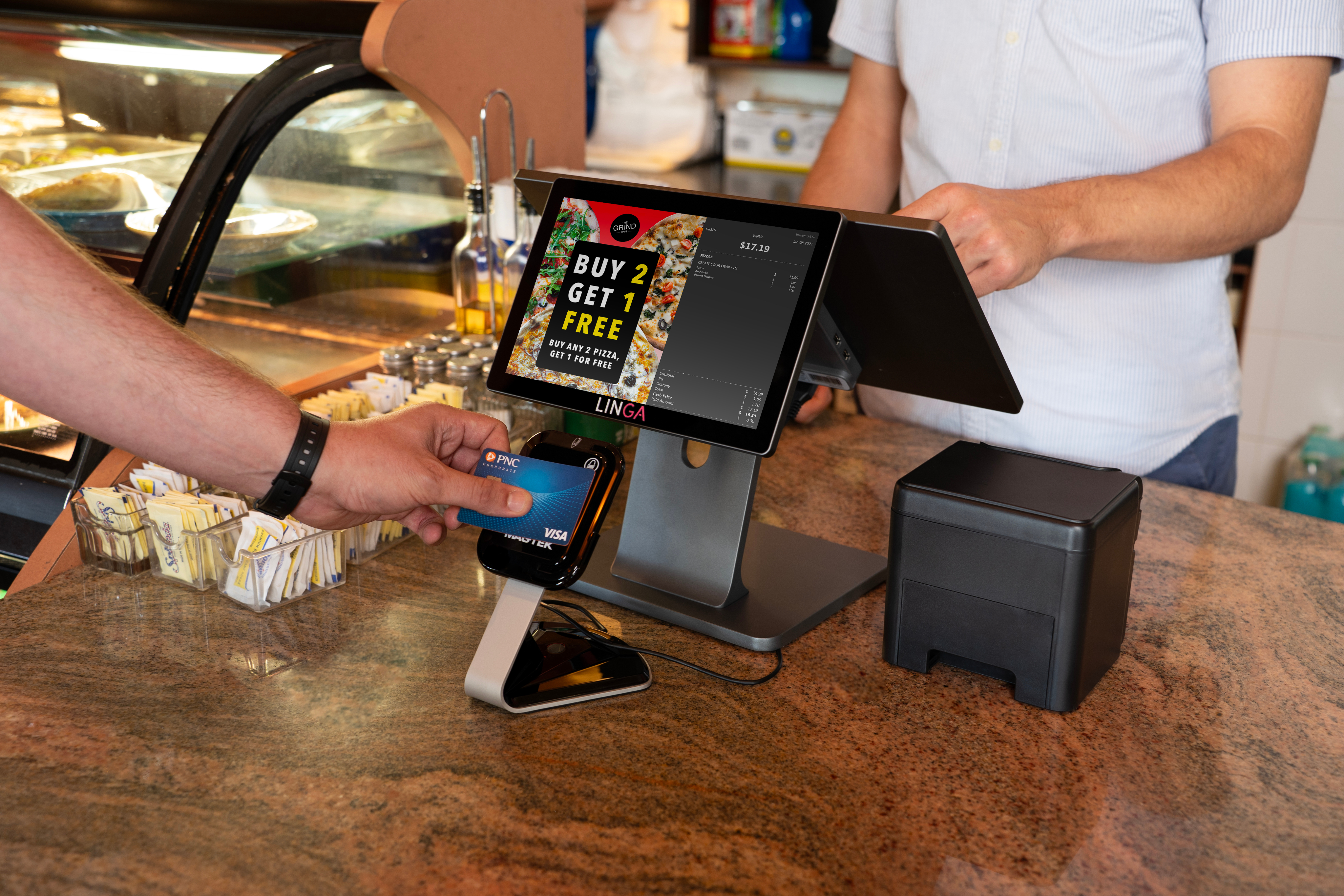 A person paying with their PNC credit card at a quick-service restaurant.