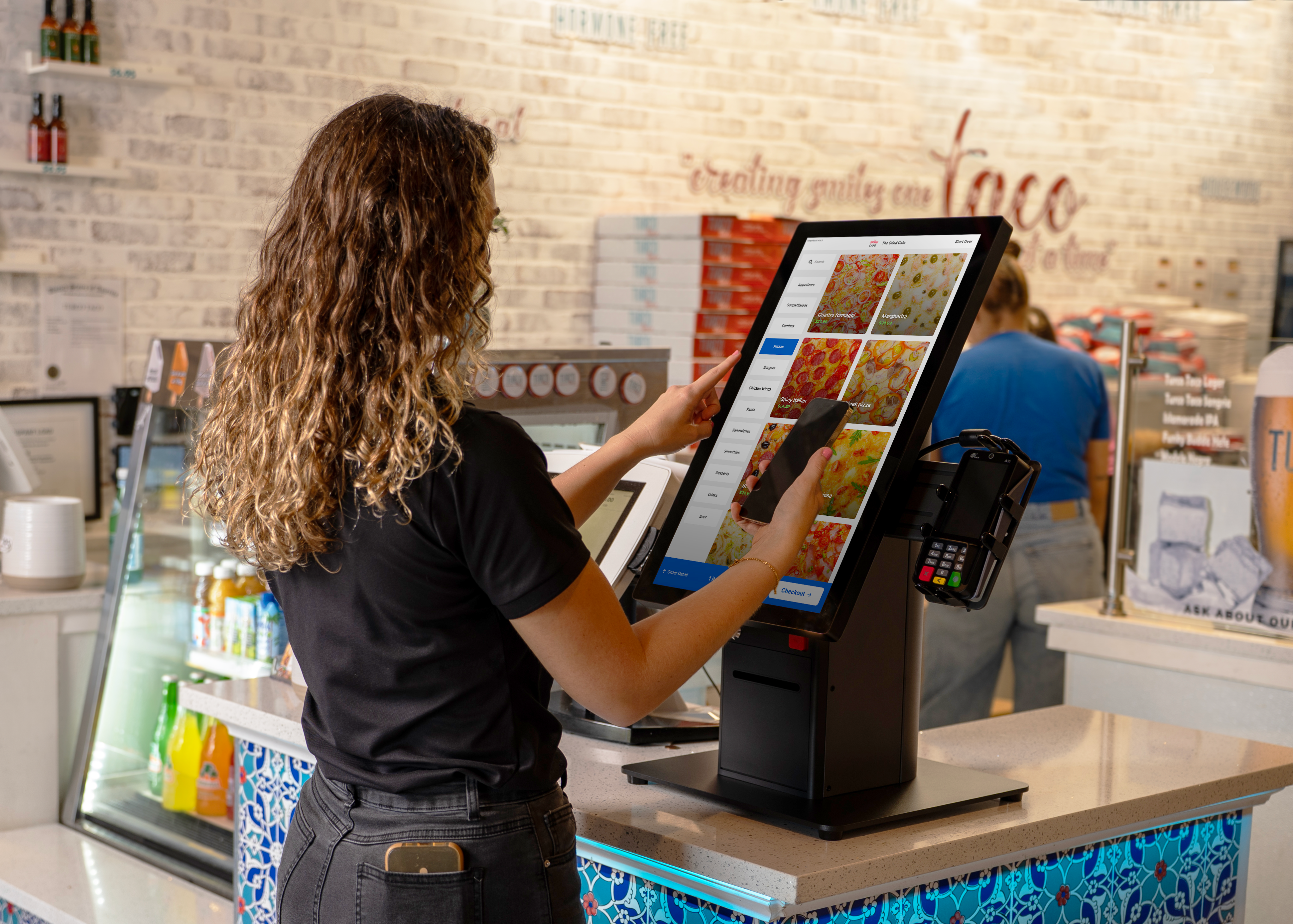 A customer ordering his meal using a LINGA kiosk.