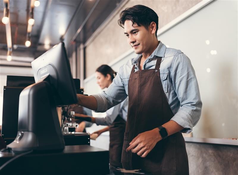 A restaurant employee taking an order using LINGA POS.